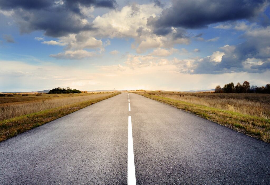 Photo of a quiet straight road heading into the distance